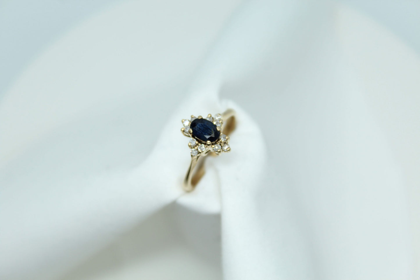 .50CT Blue Oval Sapphire .12CT TW DIA 14K YG Ladies Ring